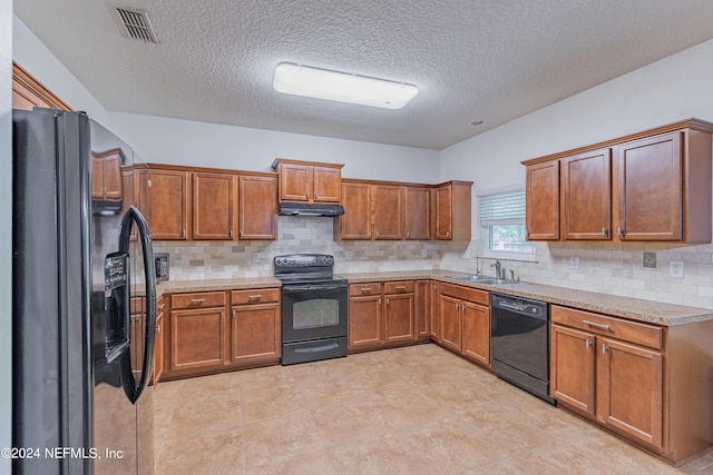 kitchen featuring black appliances, sink, tasteful backsplash, and light tile patterned floors