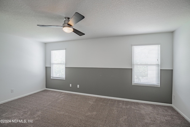 empty room featuring a ceiling fan, carpet, and a textured ceiling