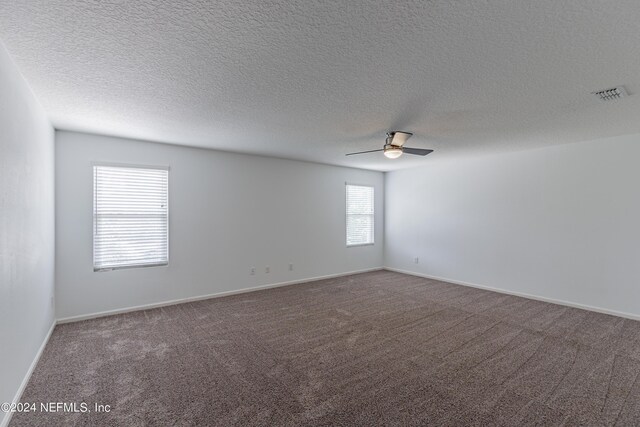 empty room featuring a textured ceiling, carpet flooring, and ceiling fan