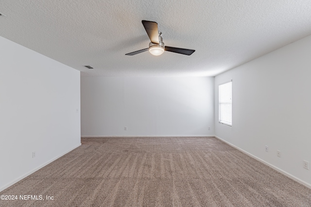 spare room with ceiling fan, a textured ceiling, and carpet floors