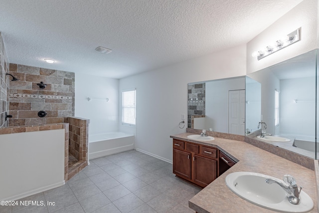 full bathroom featuring double vanity, a garden tub, walk in shower, and a sink