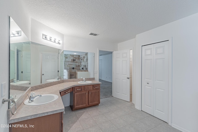 full bathroom featuring visible vents, toilet, a textured ceiling, vanity, and a shower stall