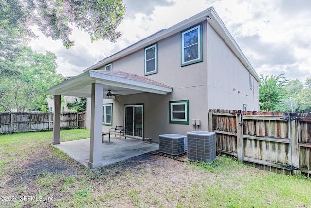 rear view of property with central AC unit, a patio area, a fenced backyard, and a ceiling fan