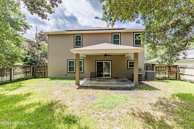 back of house featuring ceiling fan, a patio, central AC unit, and a lawn