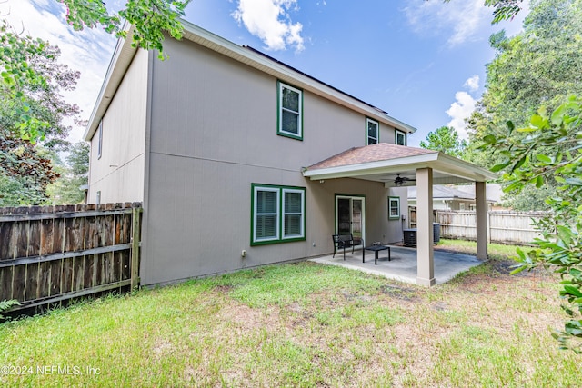 rear view of house featuring a patio area, fence, a ceiling fan, and a yard