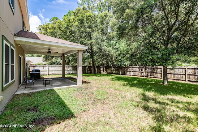 view of yard featuring ceiling fan and a patio