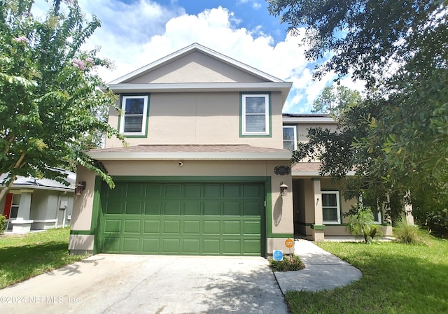 view of front of property with a garage and a front lawn