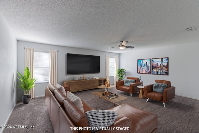 living room featuring a textured ceiling, carpet flooring, and ceiling fan