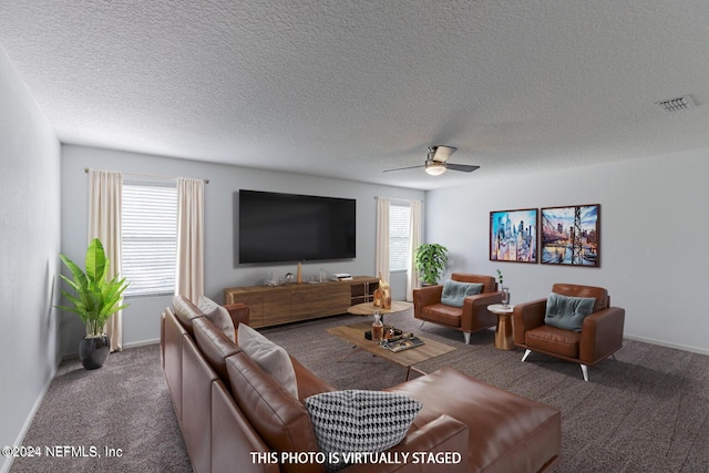 living room featuring carpet, visible vents, ceiling fan, a textured ceiling, and baseboards