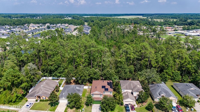 birds eye view of property with a wooded view and a residential view