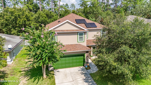 view of property with solar panels and a garage