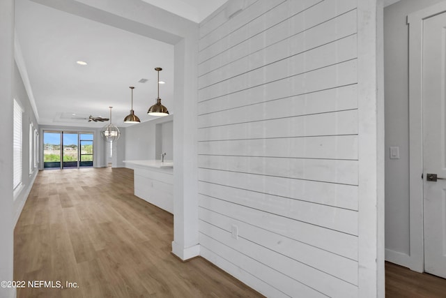 hallway with light hardwood / wood-style floors