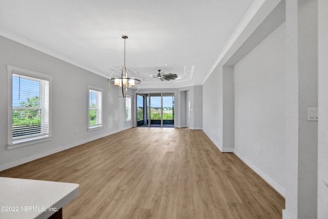 unfurnished living room featuring ceiling fan with notable chandelier, a tray ceiling, crown molding, and light wood-type flooring