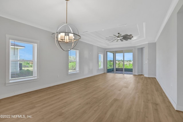 unfurnished living room with crown molding, light hardwood / wood-style floors, ceiling fan with notable chandelier, and a raised ceiling