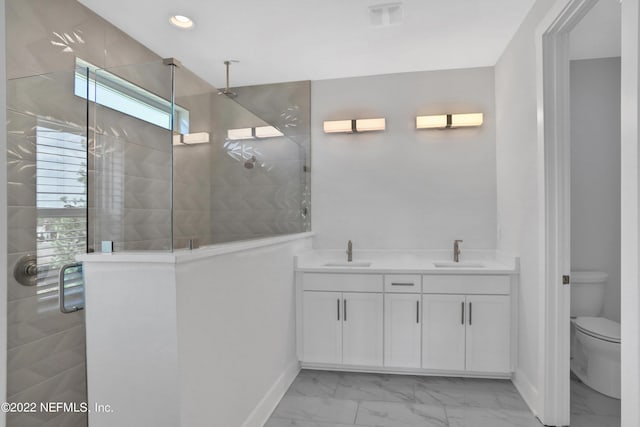 bathroom featuring walk in shower, vanity, and toilet