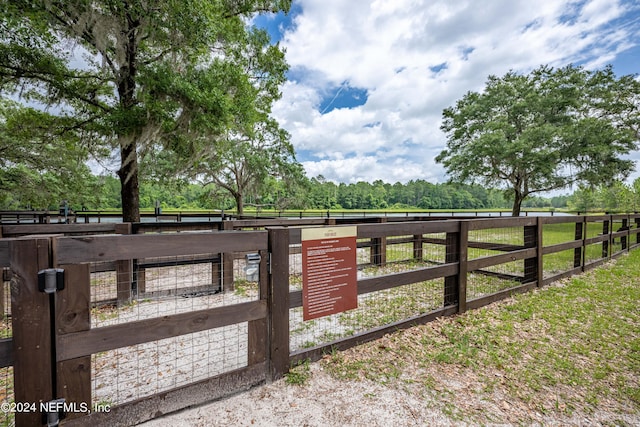 view of gate with a rural view