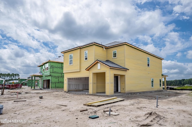 rear view of house with a garage