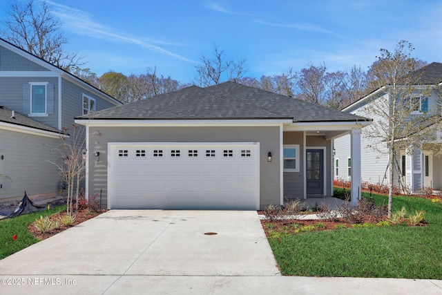 view of front of property with a garage and a front yard