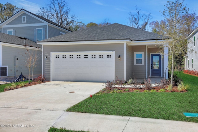 view of front facade with a garage and a front lawn