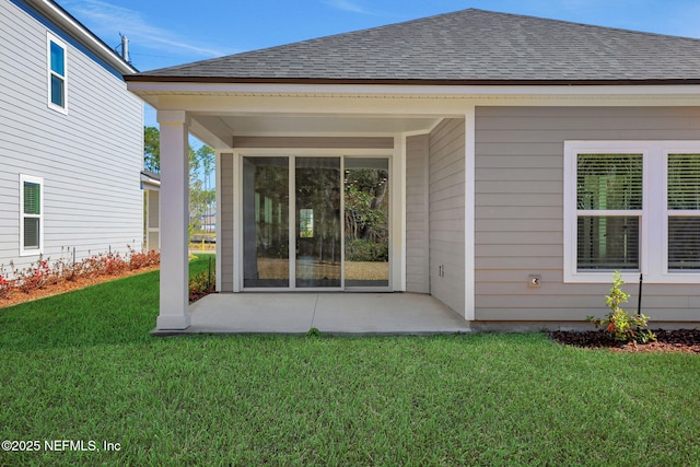 rear view of house with a yard and a patio area