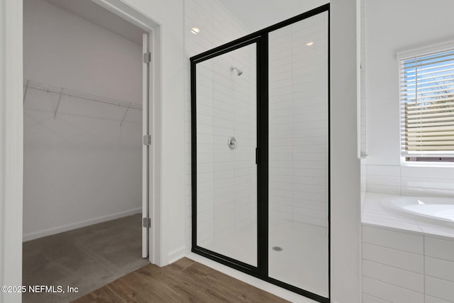 bathroom featuring separate shower and tub and hardwood / wood-style floors