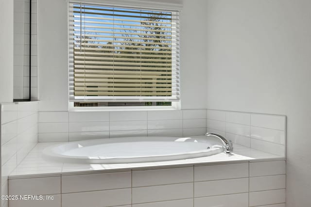 bathroom featuring tiled tub