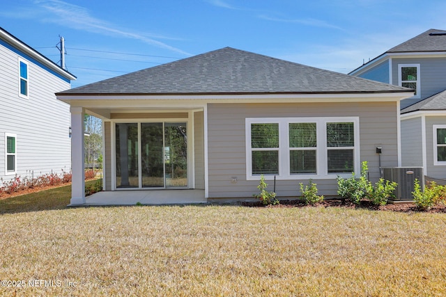 rear view of house with central AC unit, a patio, and a lawn