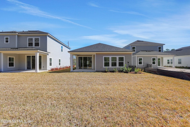 back of house with cooling unit, a patio, and a lawn