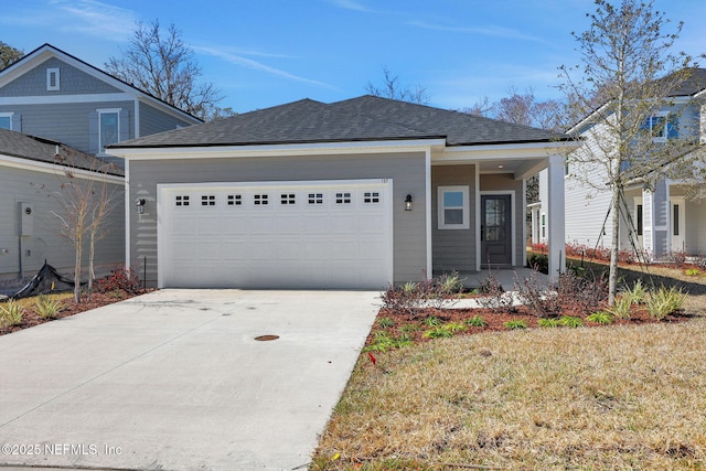 view of front of property with a garage and a front lawn