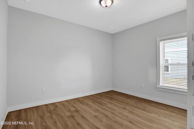 spare room with light hardwood / wood-style flooring