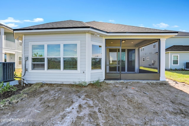 rear view of property featuring cooling unit and a sunroom