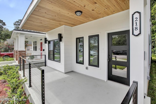 view of exterior entry featuring a porch