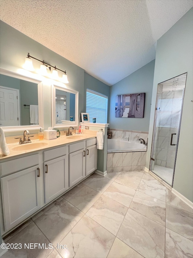 full bath featuring a bath, double vanity, vaulted ceiling, and a sink