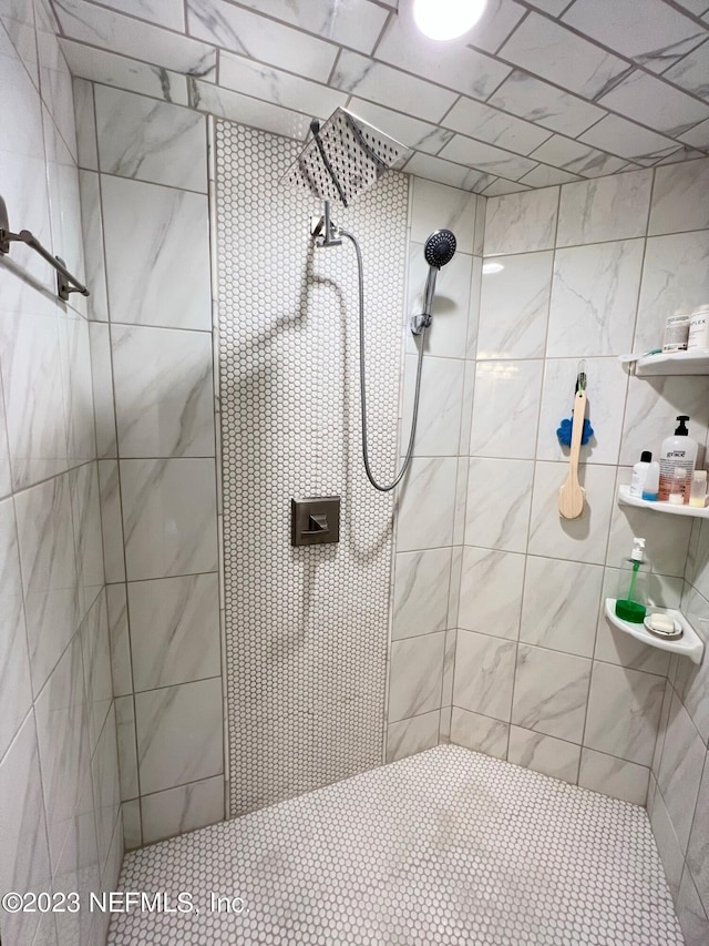 full bath with a tile shower