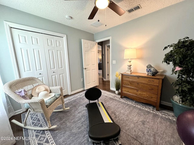 sitting room featuring visible vents, ceiling fan, a textured ceiling, and baseboards