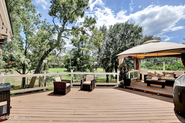 deck with a gazebo and an outdoor hangout area