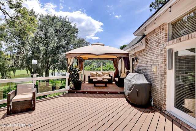 deck with a gazebo, area for grilling, and outdoor lounge area