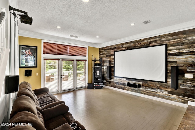 home theater featuring french doors, a textured ceiling, and crown molding