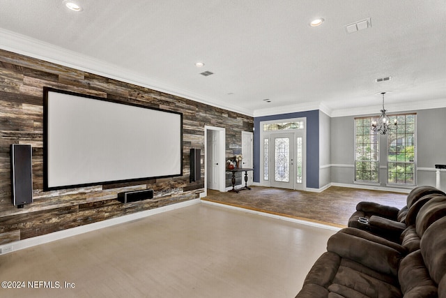 cinema featuring a textured ceiling, an inviting chandelier, and crown molding