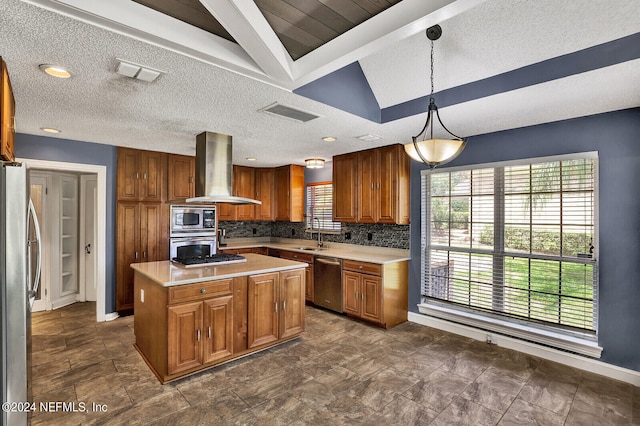 kitchen featuring a center island, wall chimney exhaust hood, decorative backsplash, appliances with stainless steel finishes, and decorative light fixtures