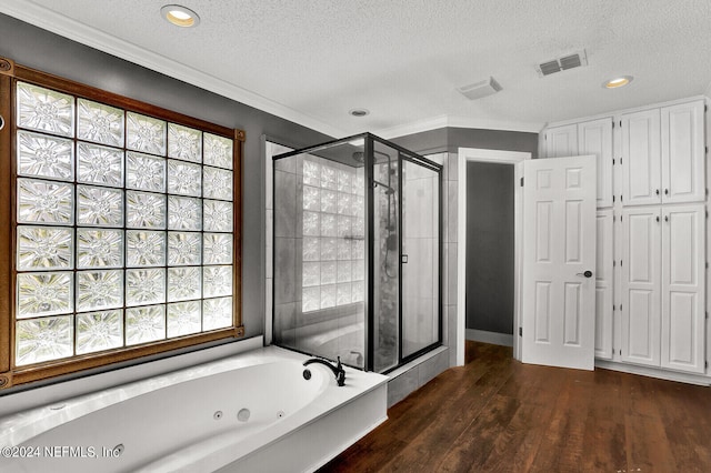 bathroom featuring a healthy amount of sunlight, wood-type flooring, a textured ceiling, and shower with separate bathtub