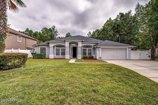 single story home with a garage and a front yard