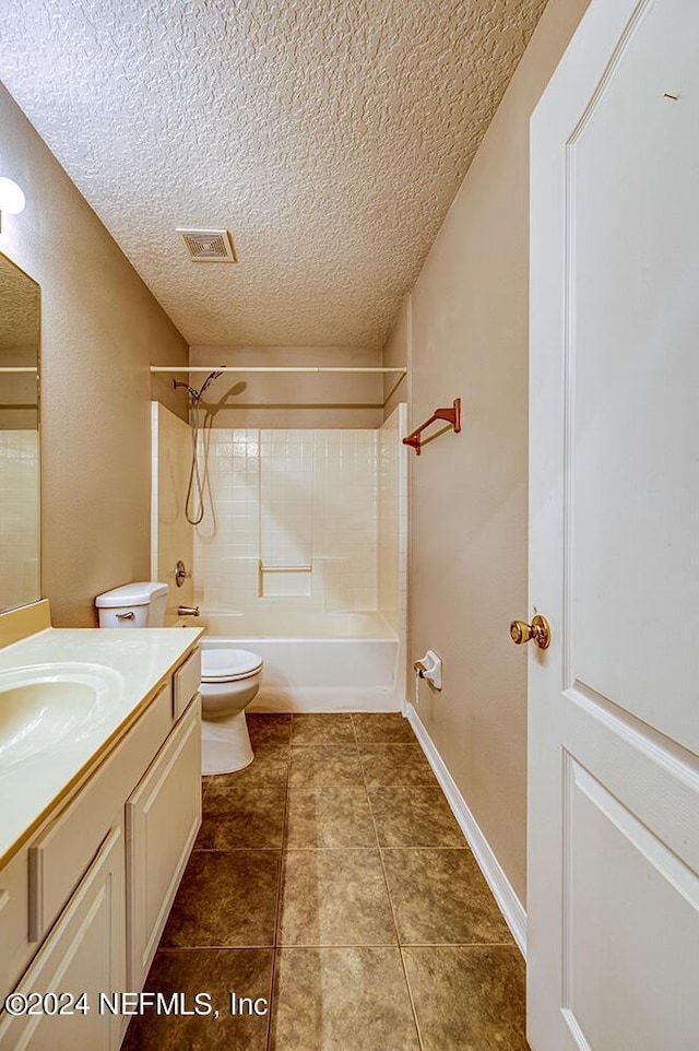 bathroom with a textured ceiling, shower / tub combination, toilet, vanity, and visible vents