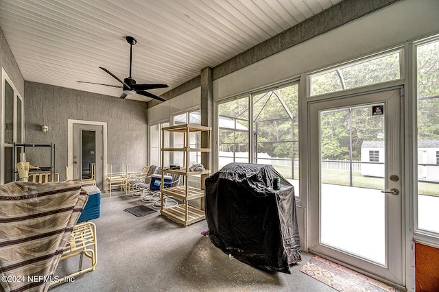 sunroom / solarium featuring ceiling fan and plenty of natural light