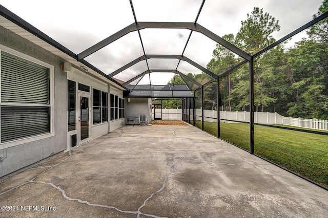 view of patio / terrace with glass enclosure and fence