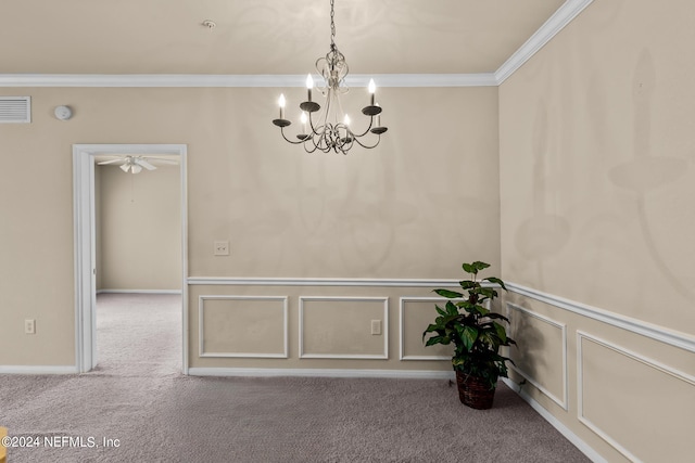 empty room with ceiling fan with notable chandelier, carpet floors, and crown molding