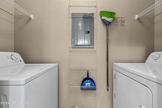 laundry room featuring electric panel and washing machine and dryer