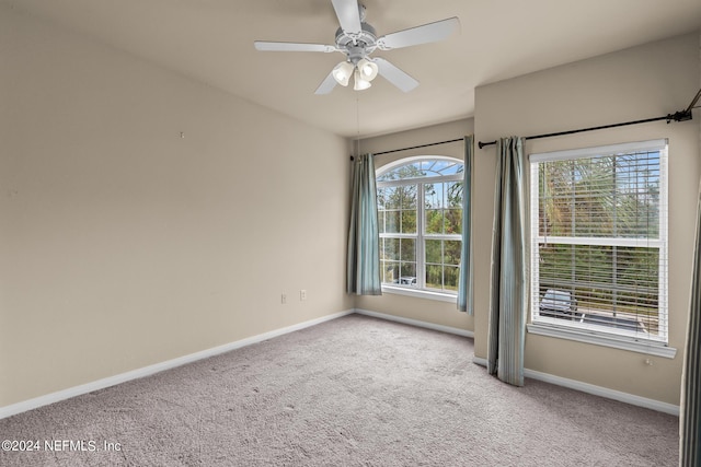 spare room featuring ceiling fan and light colored carpet