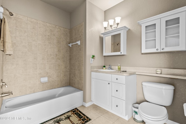 full bathroom featuring tile patterned flooring, tiled shower / bath combo, toilet, and vanity