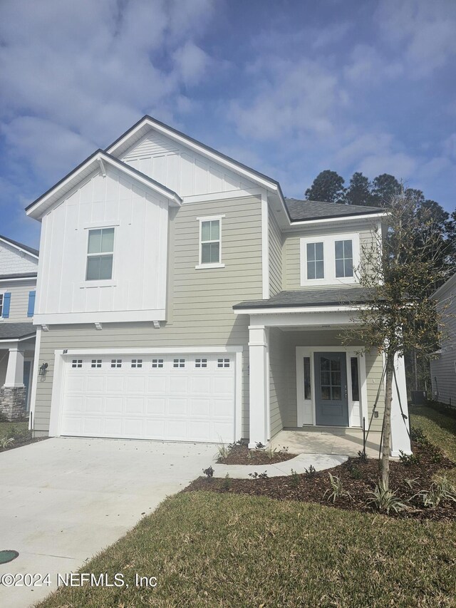 view of front facade featuring covered porch and a garage